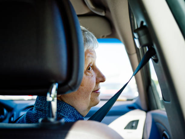 Senior woman traveling by car stock photo