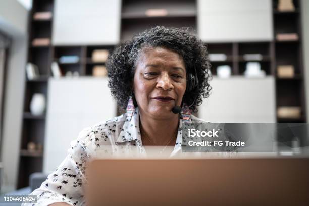 Senior woman working as customer service representative at home