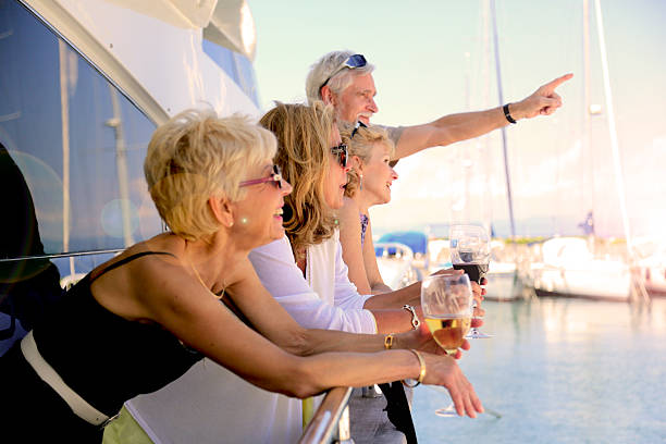 Seniors on yacht observing the beauty of the summer sky stock photo