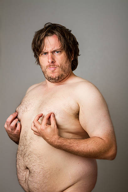 Sensual fat man playing with his nipples stock photo