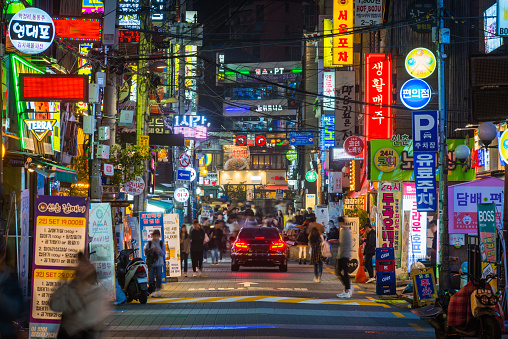 People on the crowded neon night streets of Sinchon in the heart of Seoul, South Korea’s vibrant capital city.