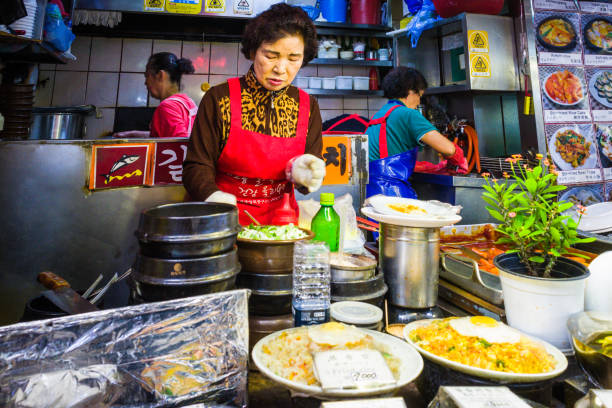 Seoul women chefs preparing food at busy market stall Korea stock photo