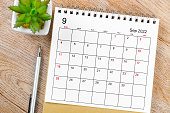 istock September 2022 desk calendar with pen on wooden table. 1389688728