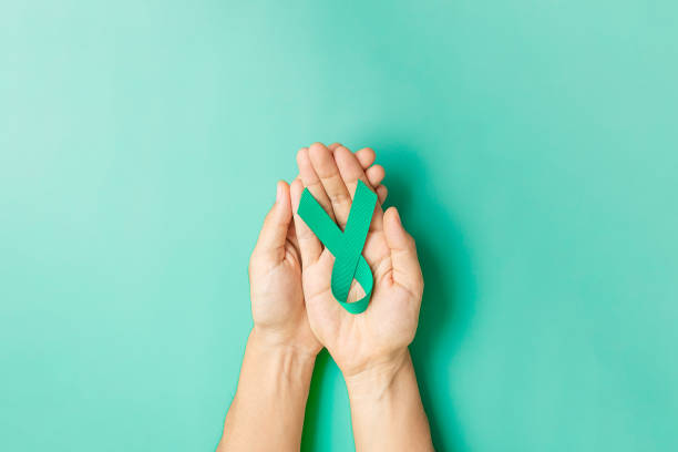 September Ovarian cancer Awareness month, Woman holding teal Ribbon color for supporting people living, and illness. Healthcare and world cancer day concepts stock photo