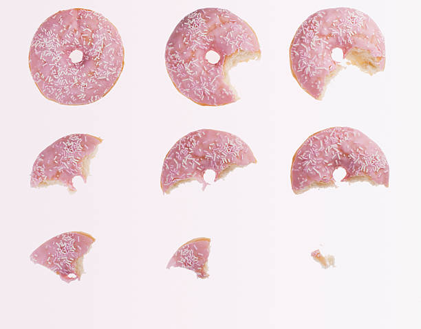 Sequence of bites taken from pink donut  eaten stock pictures, royalty-free photos & images