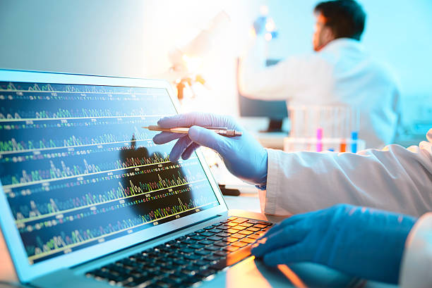 DNA Sequence A scientist looking at a DNA sequence genetic research stock pictures, royalty-free photos & images