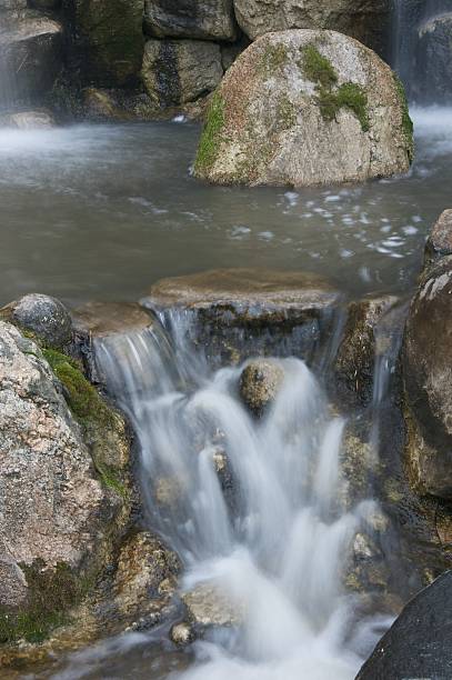 Serene Boulder and Waterfall stock photo