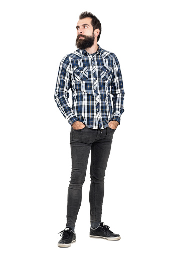 serious-bearded-hipster-in-plaid-shirt-looking-away-picture-id507711062