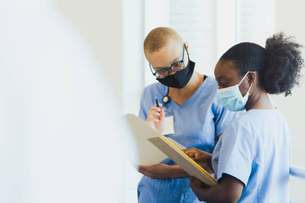 Serious doctors examine patient's test results stock photo