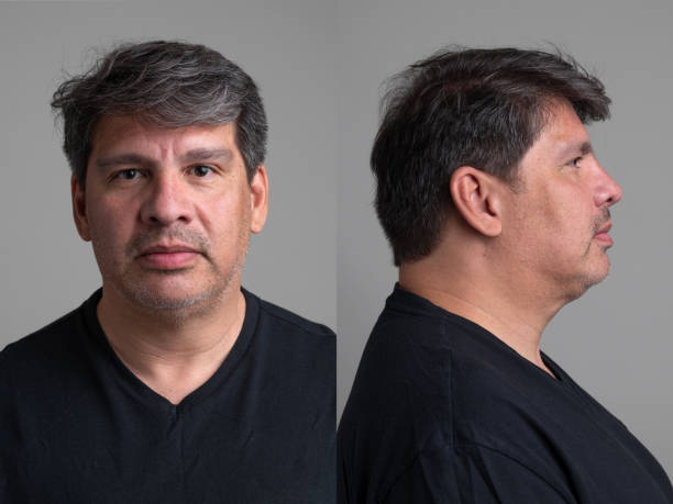Serious hispanic mature man front and profile mugshots stock photo