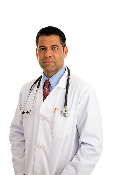 Serious mid adult male doctor with hand in pockets stock photo