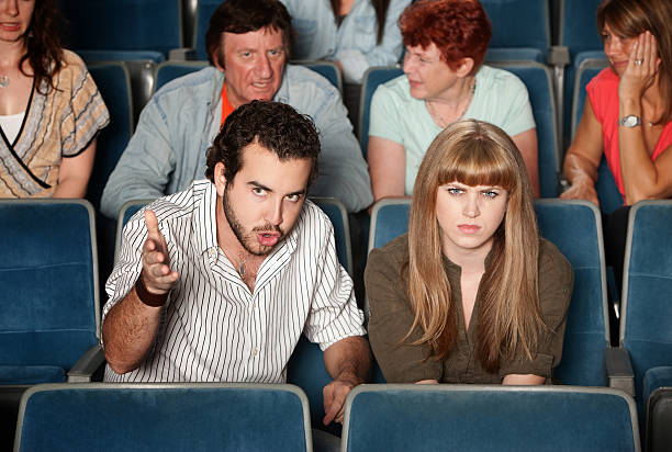 Serious Moviegoers Serious movie fans angry in a theater furious photos stock pictures, royalty-free photos & images