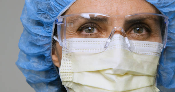 Serious, overworked, female health care worker Mature serious overworked, female mature health care worker looking at the camera nurse face stock pictures, royalty-free photos & images