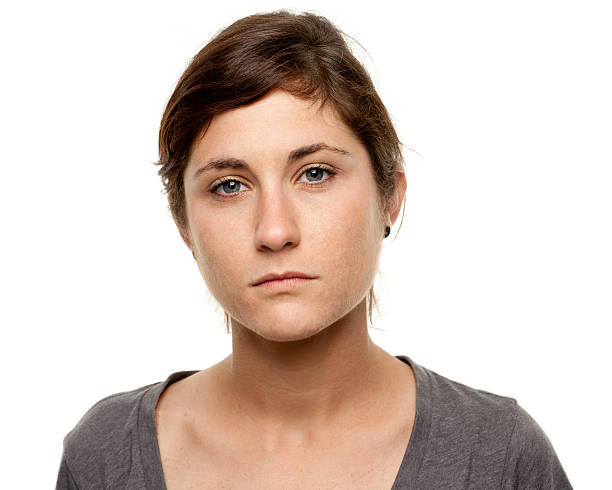 Serious Young Woman Blank Expression Mug Shot Portrait Portrait of a woman on a white background. http://s3.amazonaws.com/drbimages/m/jealac.jpg blank expression stock pictures, royalty-free photos & images