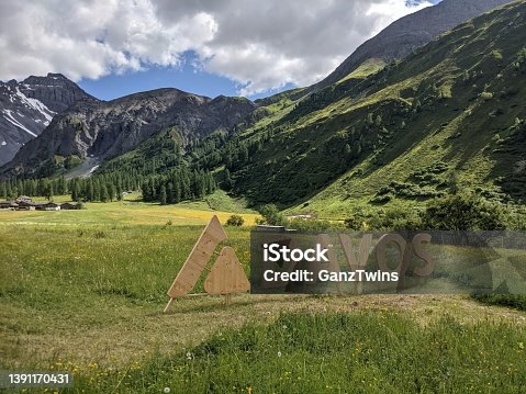 istock Sertig Valley at Davos Klosters Mountain with sign banner of Davos Tourism. great view to background mountains 1391170431