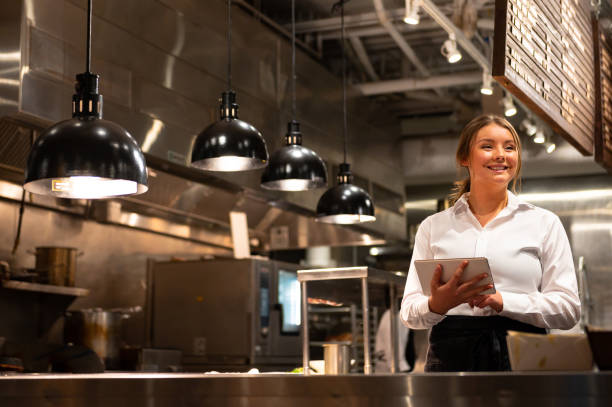 Server adding a new order with a tablet Waitress with a digital tablet. Foodservice and hospitality workers. Restaurant staff working. commercial kitchen stock pictures, royalty-free photos & images