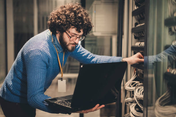 Server Rooms-IT engineer at workplace stock photo