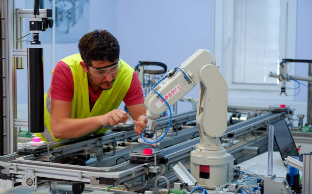 Service Engineer repairing robot arm stock photo