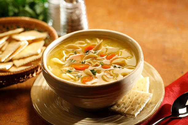 Serving of chicken noodle soup in a bowl stock photo