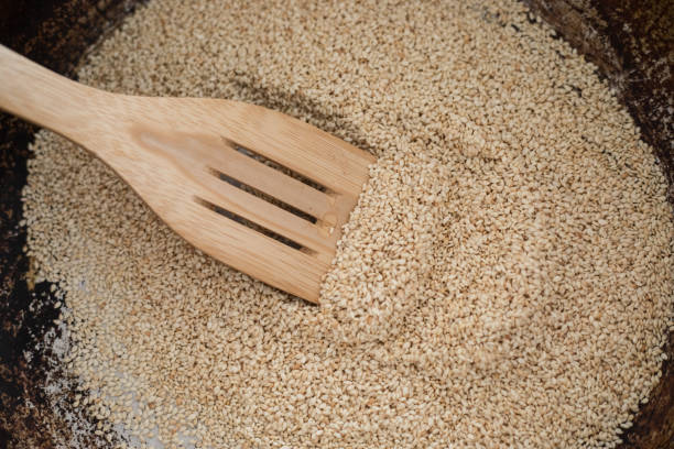 Sesame seed toasting in frying pan, close-up, no people stock photo