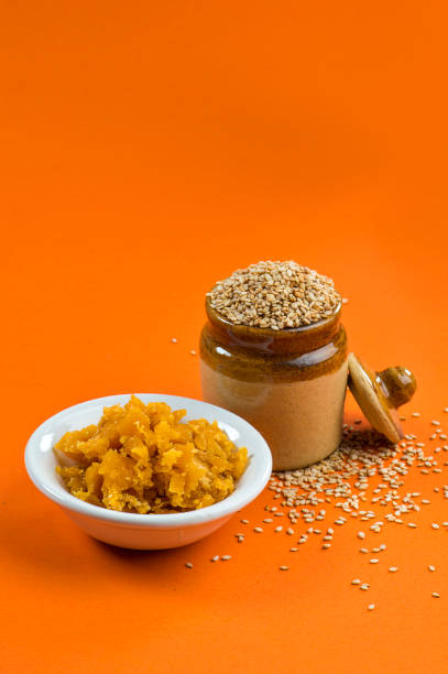 Sesame Seeds in clay pot with Jaggery in bowl stock photo