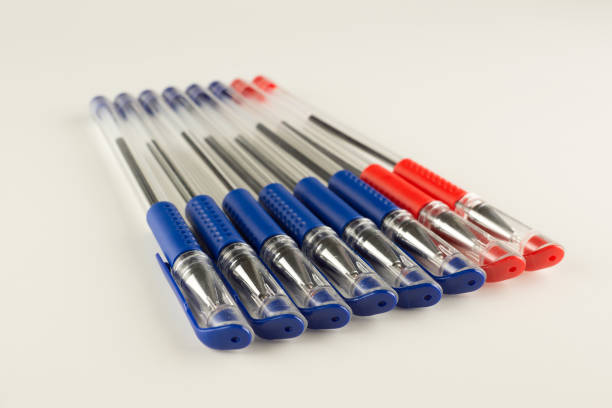 set of blue ballpoint pens lined up hardly stock photo