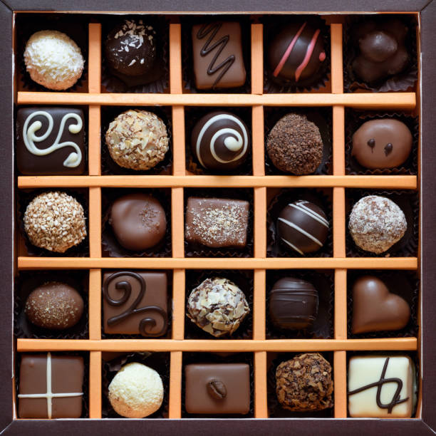 Set of chocolate sweets Top view of assorted handmade chocolate candies in a square gift box minced truffles stock pictures, royalty-free photos & images