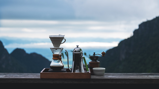 A set of coffee drip equipment with mountain background