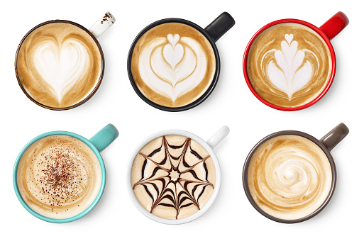 Set of six various coffee latte or cappuccino foam art isolated on white background. Top view. Colorful cups