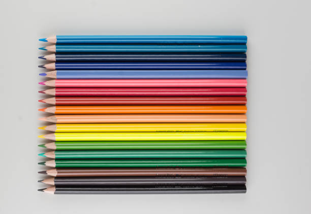 set of colored pencils lined up hardly stock photo