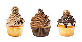 Set of different chocolate cupcakes isolated on white background.