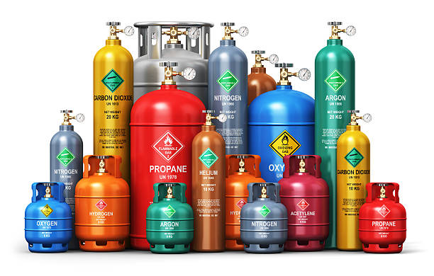 Set of different industrial liquefied gas containers Creative abstract fuel industry manufacturing business concept: 3D render illustration of the set of color metal steel containers or cylinders with different liquefied compressed natural gases LNG or LPG with high pressure gauge meters and valves isolated on white background cylinder stock pictures, royalty-free photos & images