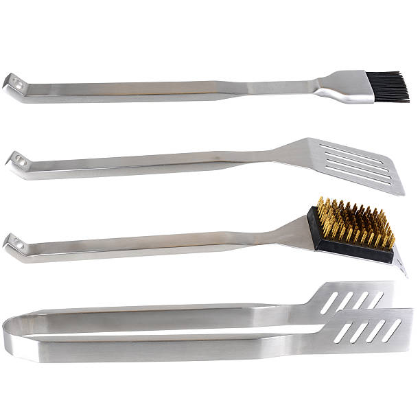 Set of four tools used to prepare, cook and clean barbecue stock photo