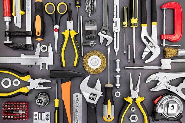 set of hand various work tools on grey background - gereedschap stockfoto's en -beelden
