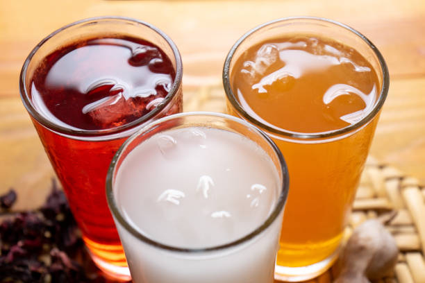 Set of mexican fresh water also called "aguas frescas". Hibiscus, tamarind and horchata on wooden background stock photo