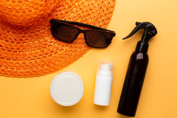 Set of sunblock moisturizer and spray to protect from sunlight on the beach. Summer vacation cosmetic concept. stock photo