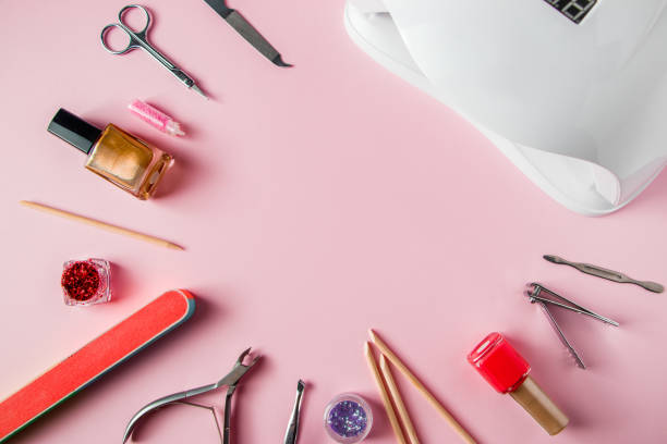 A set of tools for manicure and nail care on pink background. Workplace in a beauty salon. Place for text. A set of tools for manicure and nail care on a pink background. Workplace in a beauty salon. Place for text. nail work tool stock pictures, royalty-free photos & images