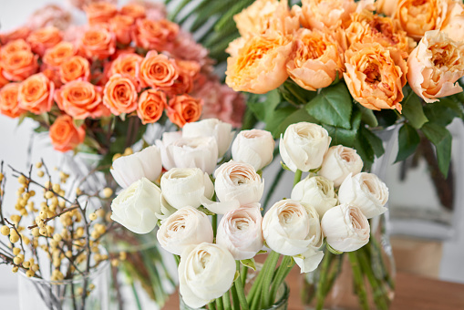 Set of white, green and orange flowers for Interior decorations. The work of the florist at a flower shop. Fresh cut flower