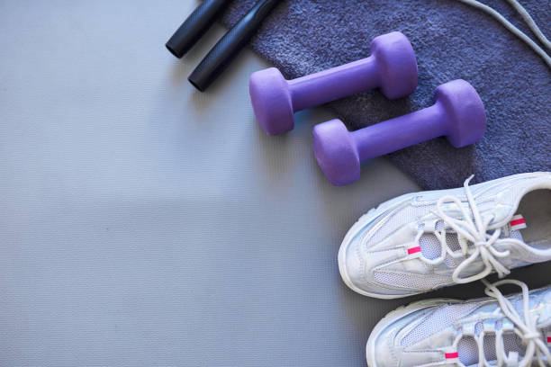 Studio shot of a variety of workout equipment against a grey background
