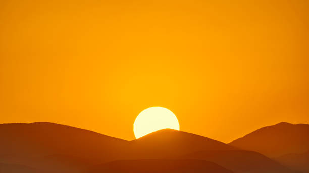 Photo of Setting sun over the mountain