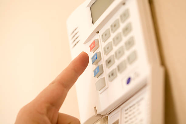 setting the alarm shot of hand pressing alarm burglar alarm stock pictures, royalty-free photos & images
