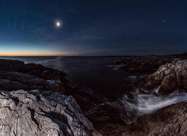 Seven Different Worlds Mercury, Venus, Saturn, Mars, Jupiter, our Moon and Earth together in pre-dawn light overlooking a rugged stretch of Nova Scotian coastline.  Long exposure with light painting. mercury planet stock pictures, royalty-free photos & images
