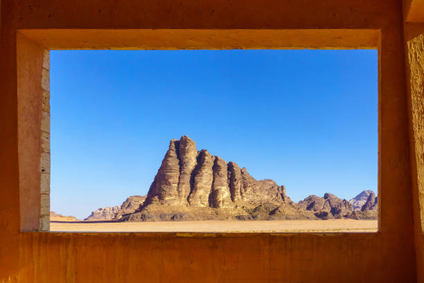 Seven Pillars of Wisdom via a window, in Wadi Rum stock photo