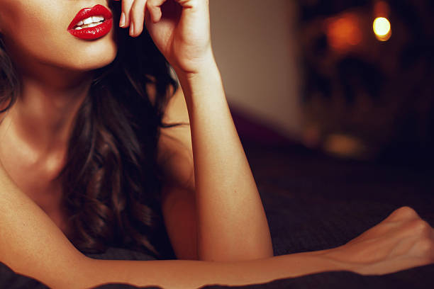 sexy frau mit roten lippen auf bed – nahaufnahme - verführerische frau stock-fotos und bilder