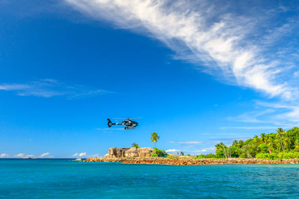 Seychelles helicopter flight Felicite Island, Seychelles - May 3, 2019: luxury helicopter scenic flight above Felicite, a small granitic island that is four kilometers east of La Digue Island. Seychelles holiday experience. granitic stock pictures, royalty-free photos & images