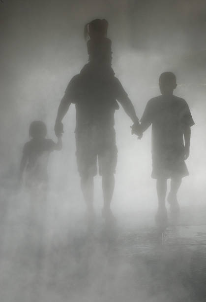 Shadow Family The shadows of a family including a father holding the hands of a little girl and boy with a little girl on his shoulders ghost boy stock pictures, royalty-free photos & images