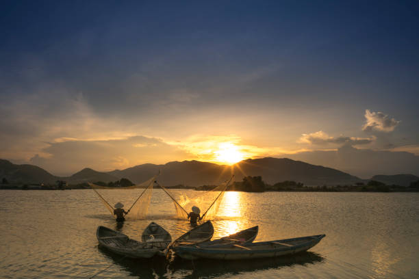 Shadow fishermen at river in the sunset. stock photo