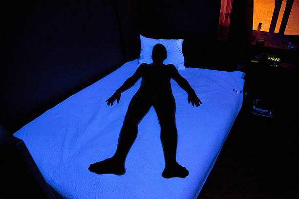 Shadow of Man Laying on Bed stock photo