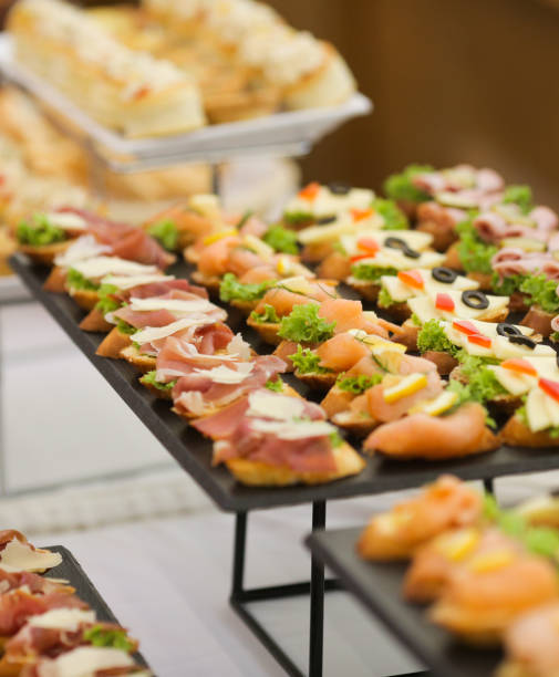 Shallow depth of field image with appetizers on a table at an event, provided by a catering company Shallow depth of field image with appetizers on a table at an event, provided by a catering company buffet photos stock pictures, royalty-free photos & images