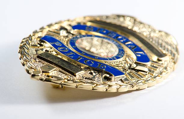 Shallow depth of field view of a police badge a close up of a generic looking police badge. police badge stock pictures, royalty-free photos & images